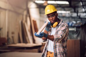 Young adult men carpenter craftman working in small business wood workshop